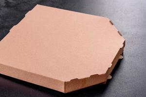 Cardboard brown box of square shape for transportation and delivery of pizza photo