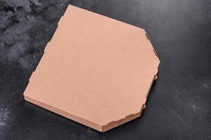 Cardboard brown box of square shape for transportation and delivery of pizza photo