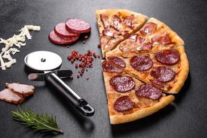 Fresh delicious pizza made in a hearth oven with four types of meat and sausage photo