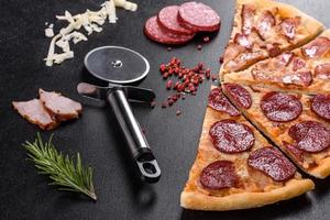 Fresh delicious pizza made in a hearth oven with four types of meat and sausage photo