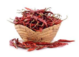 Dried chili in the basket on white background photo
