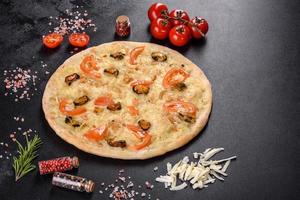 Fresh delicious pizza made in a hearth oven with shrimp mussels and other seafood