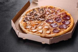 Fresh delicious pizza made in a hearth oven with four types of meat and sausage photo