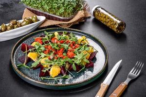 Tasty fresh healthy salad with boiled beets, microgreen and orange