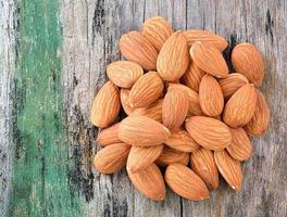 Almonds on old wood background photo
