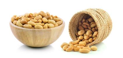 Peanuts in the basket and wood bowl on white background photo