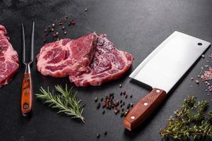 Fresh raw beef meat to make delicious juicy steak with spices and herbs photo