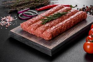 Fresh raw mince for grilled kebab with spices and herbs photo
