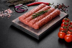 Fresh raw mince for grilled kebab with spices and herbs photo