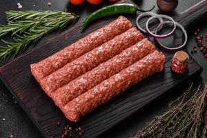 Fresh raw mince for grilled kebab with spices and herbs photo