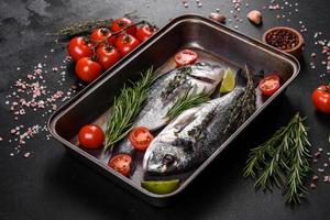 Raw dorado fish with spices cooking on cutting board. Fresh fish dorado photo