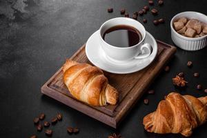 Fresh crisp delicious French croissant with a cup of fragrant coffee