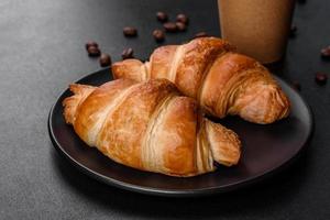 Fresh crisp delicious French croissant with a cup of fragrant coffee