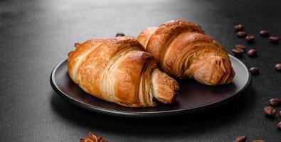 Fresh crisp delicious French croissant with a cup of fragrant coffee photo