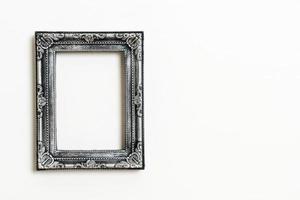 Empty picture frame on white wall background with copy space photo