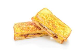 French toast ham, bacon, and cheese sandwich with egg isolated on white background photo