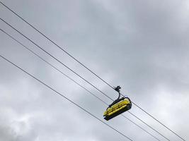 The cable car and grey sky on the background. Bottom view photo