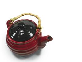 The red Chinese teapot isolated on a white background photo