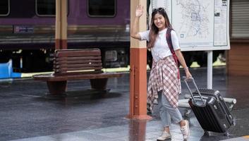 Young woman waving hand photo