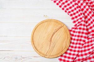 Top view wrinkled red tablecloth and plank on wooden table, mock up photo