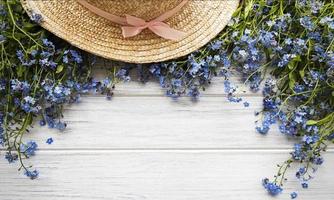 Forget-me-not flowers and straw hat photo