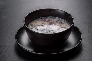 Cheese soup with fried sausages and herbs. Tasty cream cheese soup photo