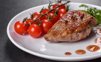 Baked duck breast with herbs and spices on a dark concrete background