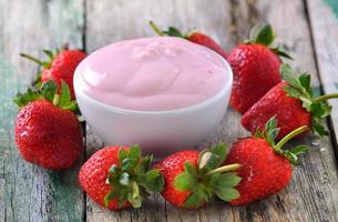 Strawberry yogurt on wood table photo