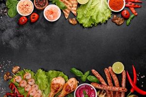 Composition of sausages, chicken, pork and shrimp prepared on grill, as well as vegetables prepared on grill with spices and herbs