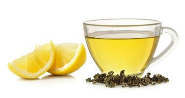 Glass of lemon tea on white background photo