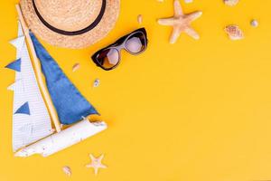 Glasses and hat with shells and sea stars on a colored background photo