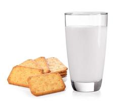 Milk in the glass and Cracker on white background photo
