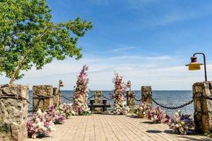 Beautiful floral composition for a wedding ceremony on the ocean coast photo