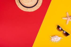 Glasses and hat with shells and sea stars on a colored background photo