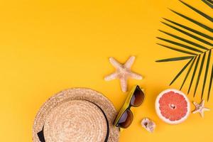 Beach accessories with shells and sea stars on a colored background photo