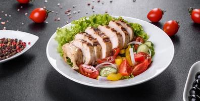 Fresh delicious salad with chicken, tomato, cucumber, onions and greens with olive oil photo