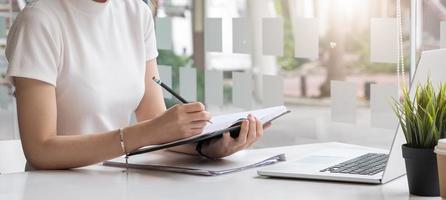 Businesswoman work with paper document on clipping board in office photo