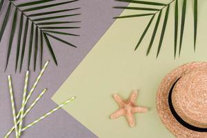 Beach accessories, glasses and hat with shells and sea stars on a colored background. Summer background photo