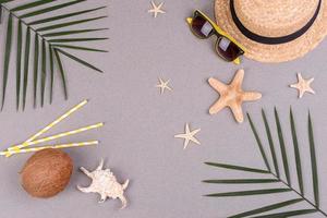 Beach accessories, glasses and hat with shells and sea stars on a colored background. Summer background photo