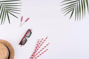 Beach accessories, glasses and hat with shells and sea stars on a colored background photo
