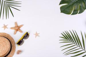 Beach accessories, glasses and hat with shells and sea stars on a colored background photo