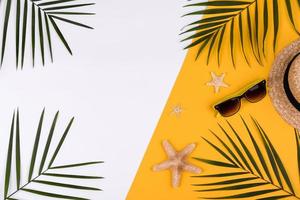 Beach accessories, glasses and hat with shells and sea stars on a colored background photo