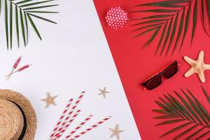 Beach accessories, glasses and hat with shells and sea stars on a colored background photo