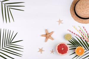 Beach accessories, glasses and hat with shells and sea stars on a colored background photo
