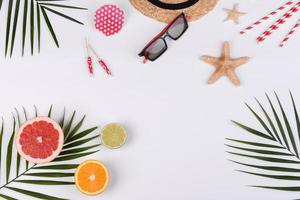 Beach accessories, glasses and hat with shells and sea stars on a colored background photo