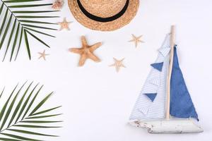 Beach accessories, glasses and hat with shells and sea stars on a colored background photo