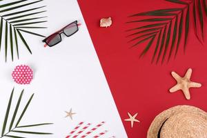 Beach accessories, glasses and hat with shells and sea stars on a colored background photo