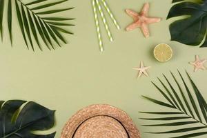 Beach accessories, glasses and hat with shells and sea stars on a colored background photo