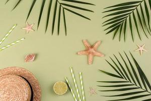 Beach accessories, glasses and hat with shells and sea stars on a colored background photo