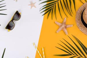 Beach accessories, glasses and hat with shells and sea stars on a colored background photo